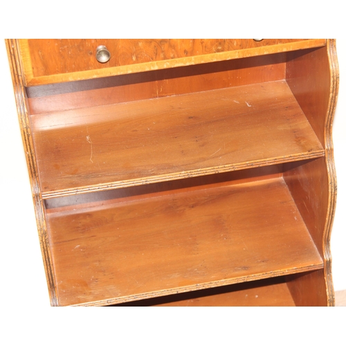 139 - An antique style yew finished waterfall bookcase with pie crust edged top, approx 46cm wide x 28cm d... 