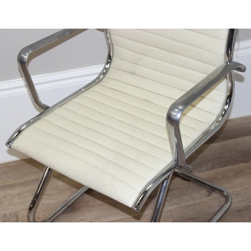 64 - A Charles Eames style chrome and white leather cantilever chair, approx 88cm tall