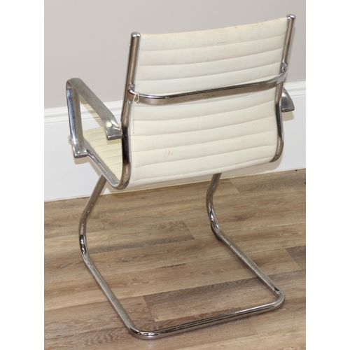 64 - A Charles Eames style chrome and white leather cantilever chair, approx 88cm tall