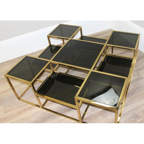 63 - In the manner of Jacob & Jacob, a retro style gold painted and smoked glass coffee table of uneven f... 