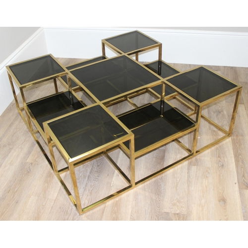 63 - In the manner of Jacob & Jacob, a retro style gold painted and smoked glass coffee table of uneven f... 