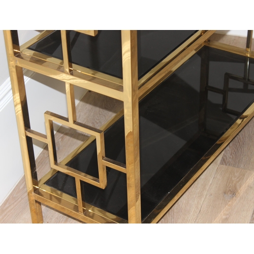 61 - An impressive gilt metal and smoked glass shelving unit or bookcase, approx 107cm wide x 38cm deep x... 