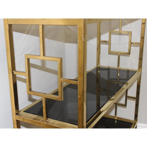 61 - An impressive gilt metal and smoked glass shelving unit or bookcase, approx 107cm wide x 38cm deep x... 