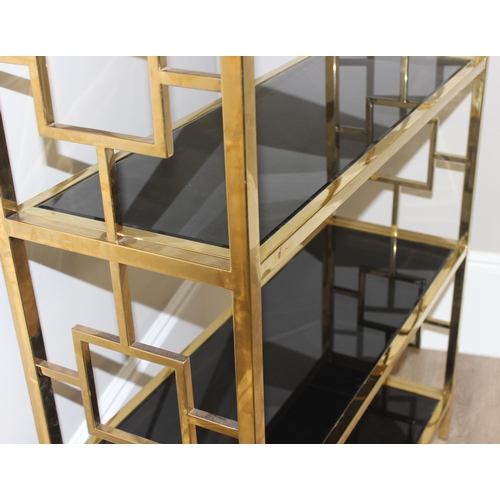 61 - An impressive gilt metal and smoked glass shelving unit or bookcase, approx 107cm wide x 38cm deep x... 