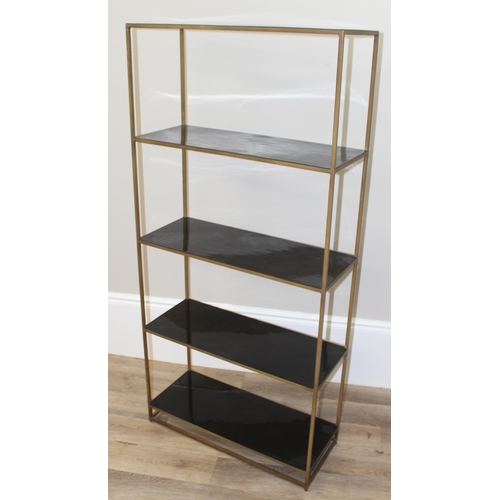 62 - A retro brass framed and black glass shelving unit or bookcase, approx 75cm wide x 30cm deep x 161cm... 