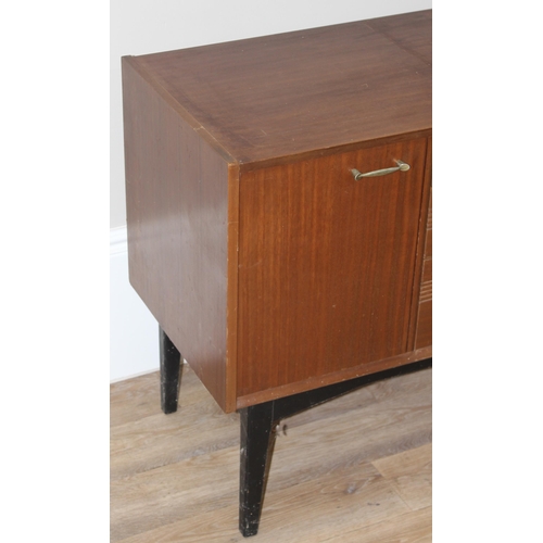 136 - A vintage sideboard with 3 drawers flanked by 2 cupboards, brass handles and ebonised legs, seemingl... 