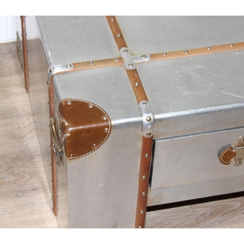 3 - An Aviator style aluminium coffee table with wooden straps and leather corners and handles, with 4 d... 