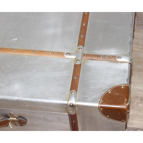 3 - An Aviator style aluminium coffee table with wooden straps and leather corners and handles, with 4 d... 