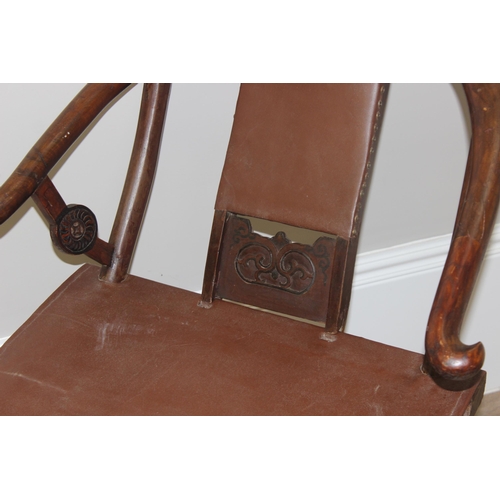 93 - An unusual Chinese Hangzhou style folding hard wood and leather chair with horseshoe back and carved... 