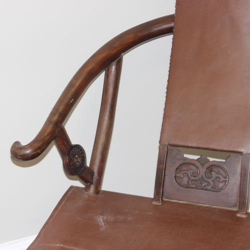 93 - An unusual Chinese Hangzhou style folding hard wood and leather chair with horseshoe back and carved... 