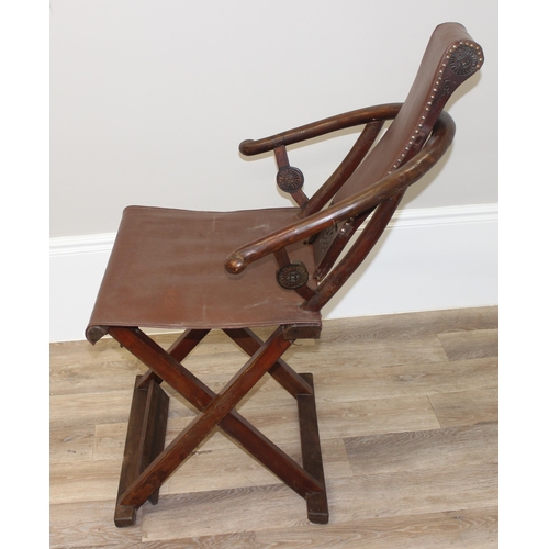 93 - An unusual Chinese Hangzhou style folding hard wood and leather chair with horseshoe back and carved... 