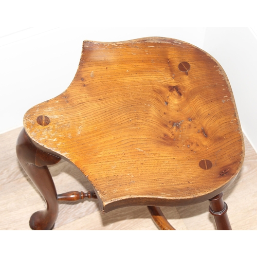 89 - A vintage Stewart Linford style elm seated saddle seated stool, unsigned, approx 39cm wide x 35cm de... 