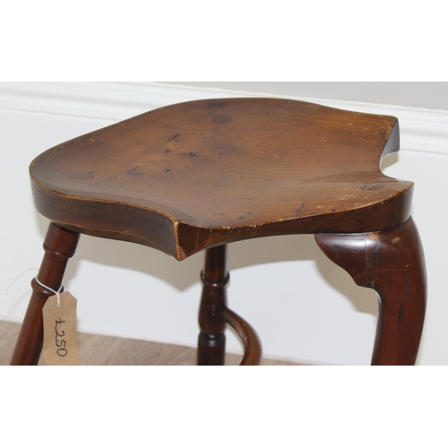 89 - A vintage Stewart Linford style elm seated saddle seated stool, unsigned, approx 39cm wide x 35cm de... 