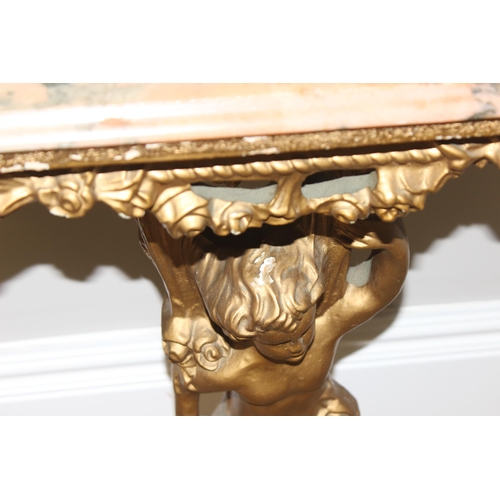 116 - An impressive gilt wood and gesso console table with lion paw feet and cherub support, coloured marb... 