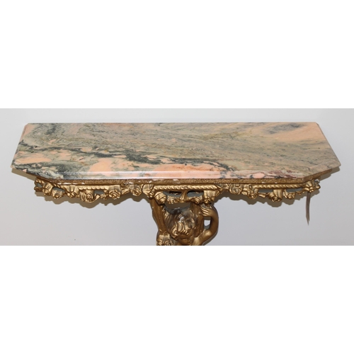 116 - An impressive gilt wood and gesso console table with lion paw feet and cherub support, coloured marb... 