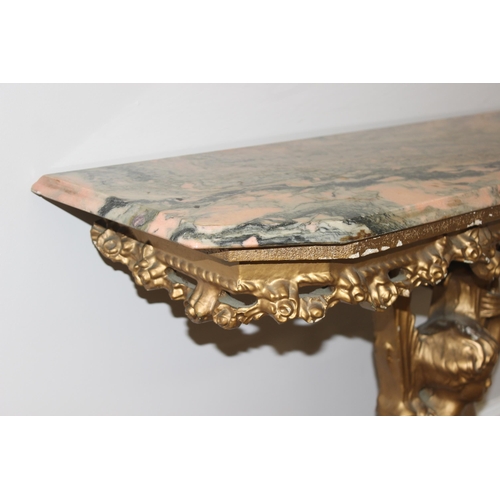 116 - An impressive gilt wood and gesso console table with lion paw feet and cherub support, coloured marb... 