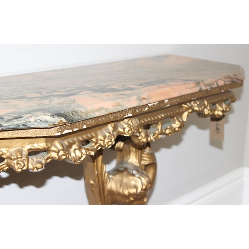 116 - An impressive gilt wood and gesso console table with lion paw feet and cherub support, coloured marb... 