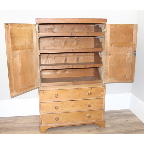 84 - A Victorian pine linen press on 3 drawer chest of drawers base, the base with bracket feet and turne... 