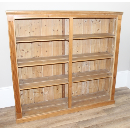 125 - A vintage reclaimed pine double bookcase, approx 162cm wide x 41cm deep x 154cm tall