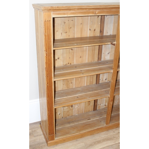 125 - A vintage reclaimed pine double bookcase, approx 162cm wide x 41cm deep x 154cm tall