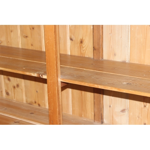 125 - A vintage reclaimed pine double bookcase, approx 162cm wide x 41cm deep x 154cm tall