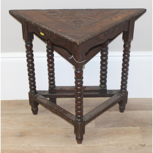 83 - An unusual Jacobean style oak drop leaf table of small proportions with carved top and bobbin turned... 