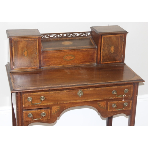 120 - A 19th century ladies writing or work desk with Sheraton inlay and fretwork details, a central stati... 