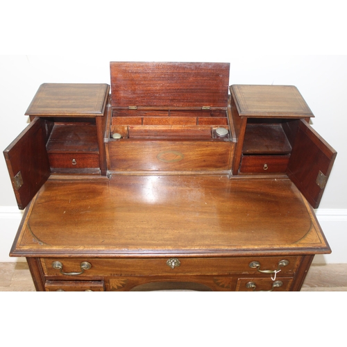 120 - A 19th century ladies writing or work desk with Sheraton inlay and fretwork details, a central stati... 