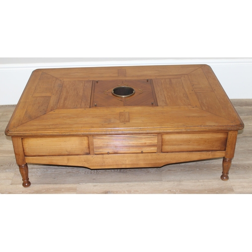 160 - A Christian Roberts Furniture low coffee table, the centre with removeable wine bottle holder and dr... 