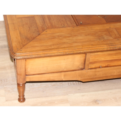 160 - A Christian Roberts Furniture low coffee table, the centre with removeable wine bottle holder and dr... 