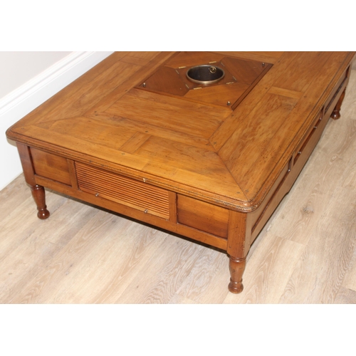 160 - A Christian Roberts Furniture low coffee table, the centre with removeable wine bottle holder and dr... 