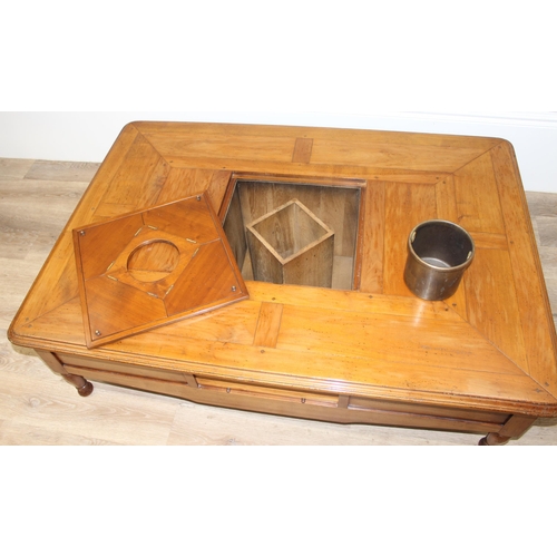 160 - A Christian Roberts Furniture low coffee table, the centre with removeable wine bottle holder and dr... 