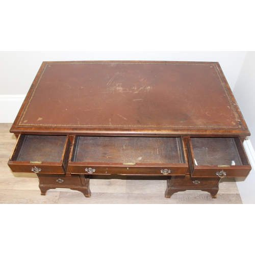 97 - Vintage mahogany twin pedestal desk with burgundy leather top, approx 135cm W x 73cm D x 74cm H