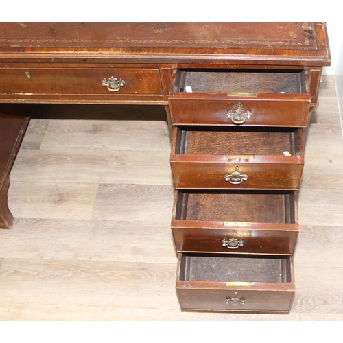 97 - Vintage mahogany twin pedestal desk with burgundy leather top, approx 135cm W x 73cm D x 74cm H