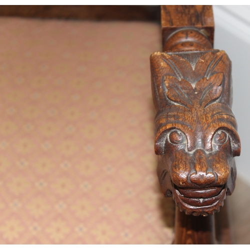 178 - Solid carved oak Wainscot style armchair with carved back panel depicting a male in profile, likely ... 