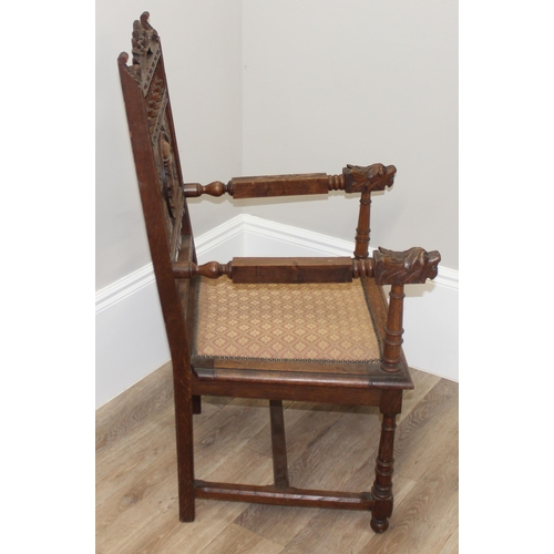 178 - Solid carved oak Wainscot style armchair with carved back panel depicting a male in profile, likely ... 