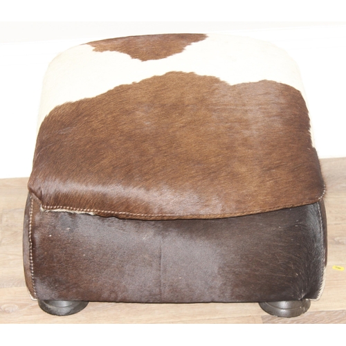 44 - A vintage style cowhide footstool, believed to be by Stone International, approx 54cm wide x 58cm de... 