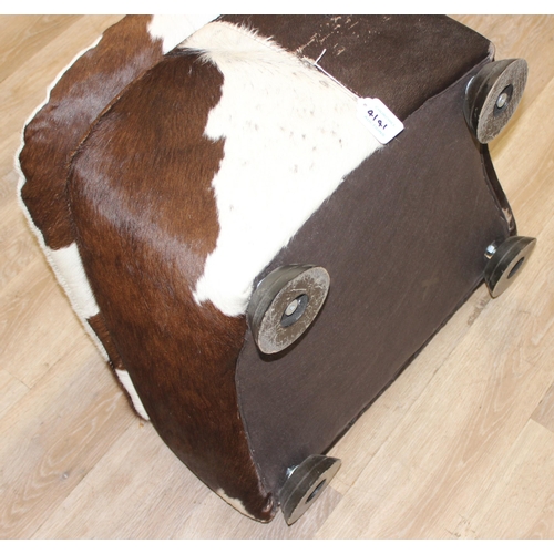 44 - A vintage style cowhide footstool, believed to be by Stone International, approx 54cm wide x 58cm de... 