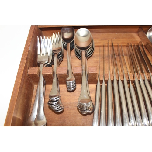 1032 - A retro Danish stainless steel cutlery set by Dansk Designs, pistol grip handles