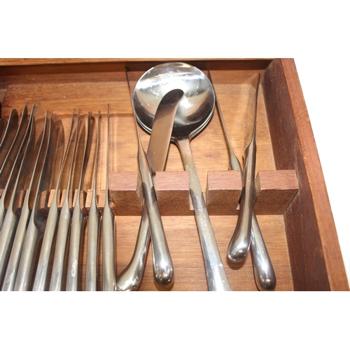 1032 - A retro Danish stainless steel cutlery set by Dansk Designs, pistol grip handles