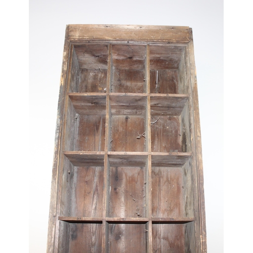 111 - A large vintage stained pine set of pigeon holes, 30 holes of 10 x 3 construction, approx 257cm tall... 