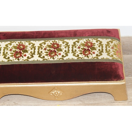 114 - A long gold painted and upholstered low foot stool, approx 122cm wide x 30cm deep x 20cm tall