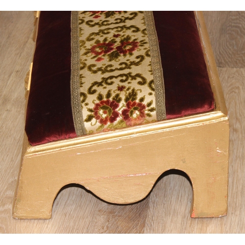 114 - A long gold painted and upholstered low foot stool, approx 122cm wide x 30cm deep x 20cm tall