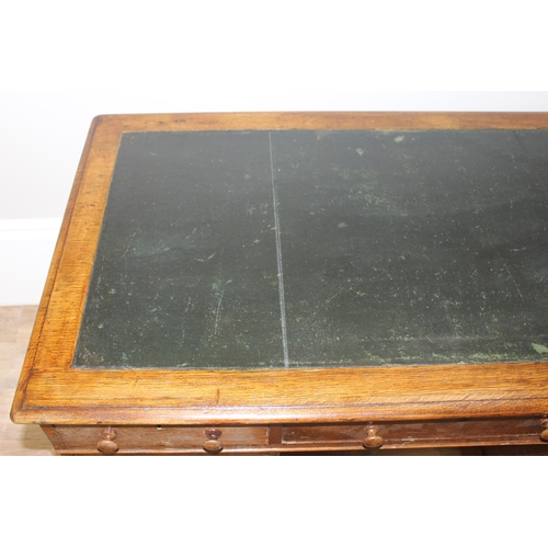 165 - A vintage Oak pedestal desk with leather inset top, approx 122cm wide x 67cm deep x 73cm tall