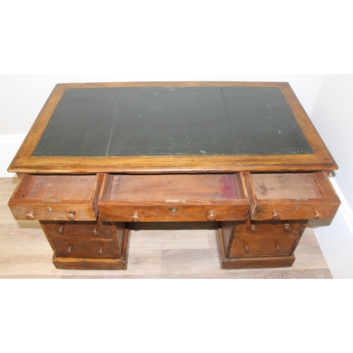 165 - A vintage Oak pedestal desk with leather inset top, approx 122cm wide x 67cm deep x 73cm tall