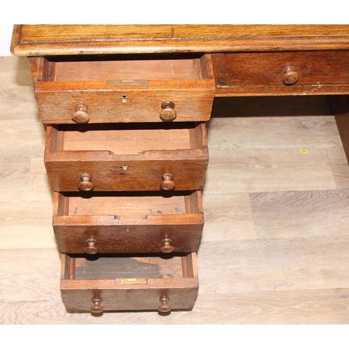 165 - A vintage Oak pedestal desk with leather inset top, approx 122cm wide x 67cm deep x 73cm tall