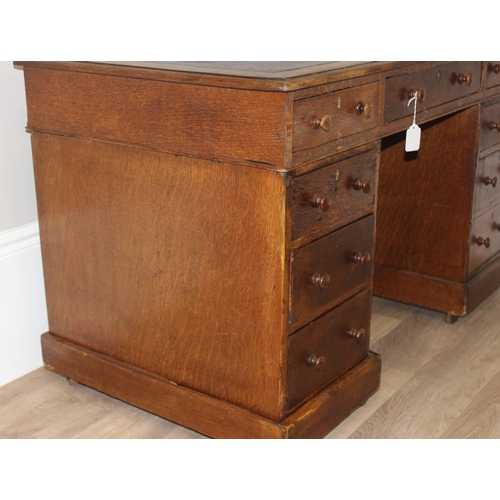 165 - A vintage Oak pedestal desk with leather inset top, approx 122cm wide x 67cm deep x 73cm tall