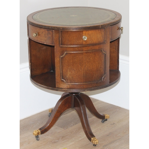 163 - A vintage leather topped drum table with 3 drawers, 3 false drawers and 3 bookcase recesses, approx ... 