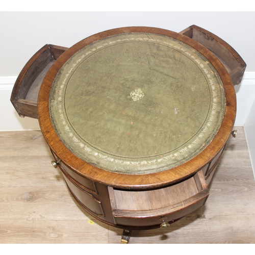 163 - A vintage leather topped drum table with 3 drawers, 3 false drawers and 3 bookcase recesses, approx ... 