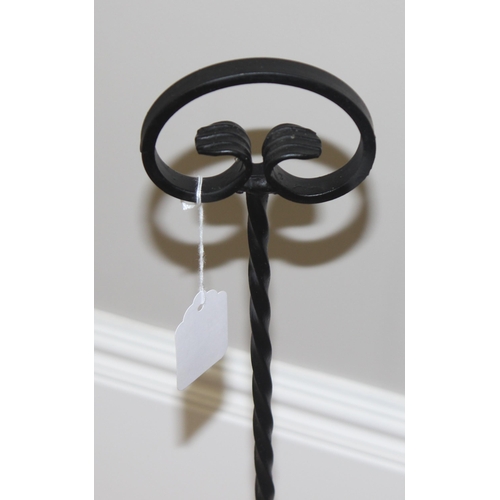 389 - A black painted wrought iron boot scraper, approx 85cm tall